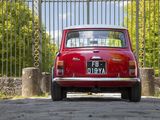 a red car that is parked in front of a gate
