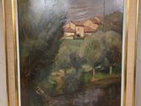 tableau représentant une maison au bord d'une rivière, encadré et accroché au mur