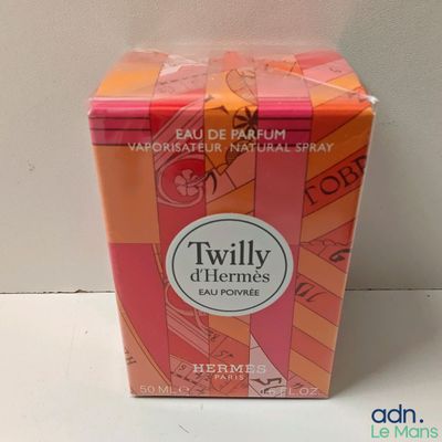 a small box of perfume sitting on a table