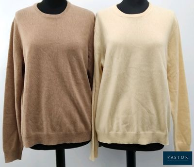 two women ' s sweaters on a mannequin stand