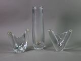 three glass vases sitting next to each other on a table