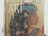 an egyptian art book sitting on top of a stack of books
