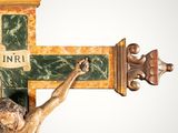 a statue of jesus on the cross with a sign on it