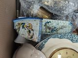 a box with a clock, a plate, and other items in it