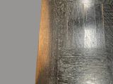 a close up view of a black wood floor