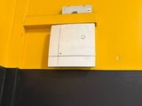 a white light switch on a yellow wall next to a black wall