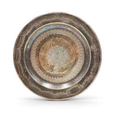 an image of a silver plate with a circular design on it