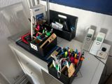 a desk with a phone, pen holder, and other office supplies on it