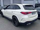 the rear end of a white mercedes suv parked in a parking lot