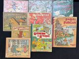 Plusieurs livres pour enfants sont alignés sur une surface noire
