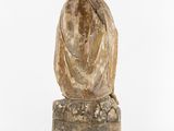 an image of a statue of a woman sitting on top of a wooden block