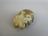 an image of a stone head on a white surface