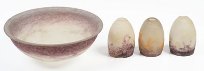 three pieces of pottery sitting next to each other on a white surface