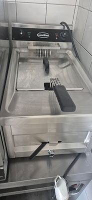 a kitchen with a stove, sink, and a dishwasher
