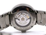 a close up of a watch on a white surface