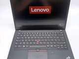 a black laptop with a red lenovo logo on the screen