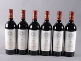 six bottles of wine lined up in a row on a table