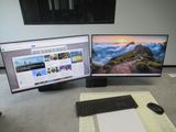 two monitors and a keyboard sitting on a desk