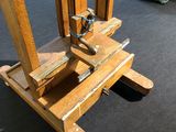 a picture of a wooden easel on display in a museum