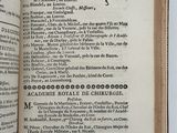 an open book on a table with a bunch of writing on it