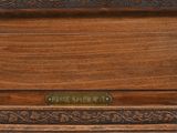 a close up of a clock on a wooden table
