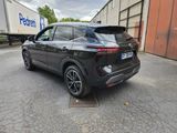 the rear end of a black suv parked in a parking lot