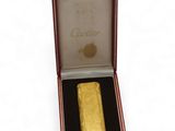 an image of a gold lighter in a red box on a white background