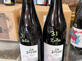 Plusieurs bouteilles de vin sont posées sur le comptoir d'un magasin.