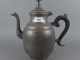 an old silver tea pot with a handle and a handle