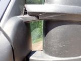 a side view mirror of a car with a bird on it