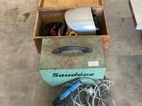 a box of tools sitting on the floor in the garage