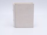 a white book sitting on top of a white surface
