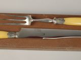 two forks and a knife in a box