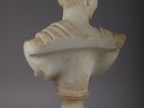 an antique marble bust of a woman on a pedestal