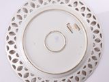 a white plate with holes in the middle of it