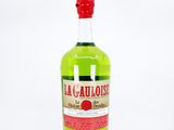 the bottle is full of a green liquid with a red cap