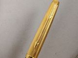 a gold pen and a silver pen sitting on a table
