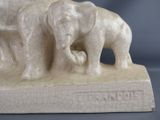 a statue of two elephants that are standing on a table