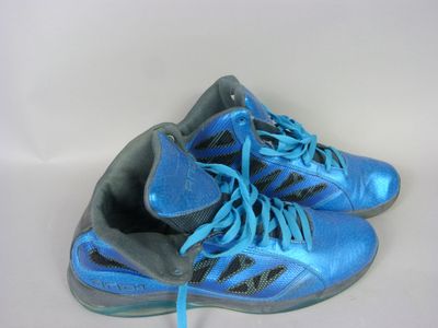 pair of blue and black shoes with blue laces on a white surface