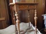 a small wooden table with a drawer on top of it
