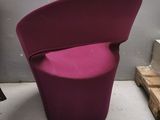 a purple chair that is sitting in a room