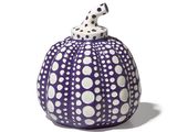 purple and white polka dot pumpkin with a dalmatian figurine on top
