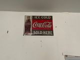a coca cola sign on the wall of a building