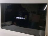 the samsung tv is sitting on a table in the living room