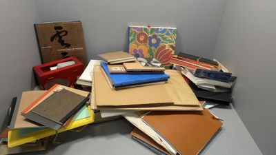 a pile of books on a table in a room