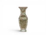 an image of a vase with a design of flowers on it