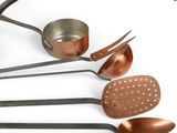 many different types of kitchen utensils on a white surface