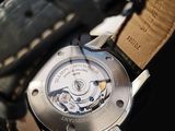 a close up of a watch on a black background
