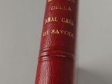 a red book with gold writing on it sitting on a table