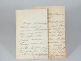 two old papers with writing on them sitting on a table